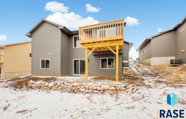 snow covered property with central AC