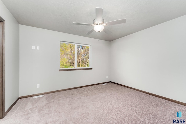 117 N Summit Ave, Tea, SD 57064 - spare room featuring a textured ceiling, light colored carpet, and ceiling fan