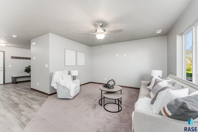 living room with ceiling fan and light hardwood / wood-style floors