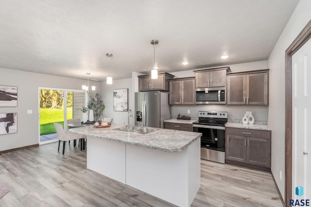 117 N Summit Ave, Tea, SD 57064 - kitchen with decorative light fixtures, an island with sink, sink, a chandelier, and stainless steel appliances