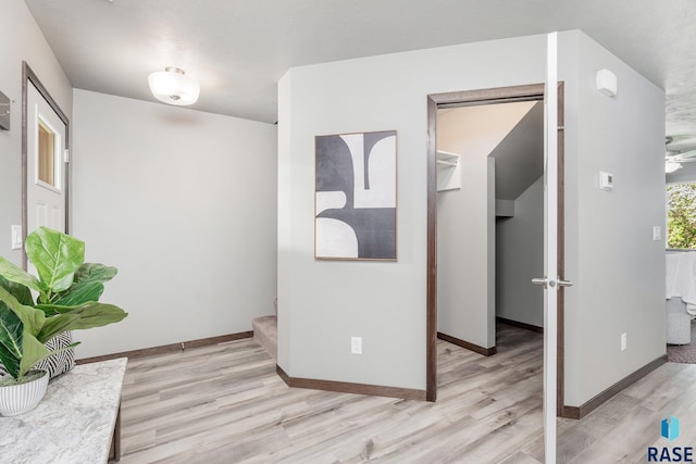 corridor with light hardwood / wood-style flooring