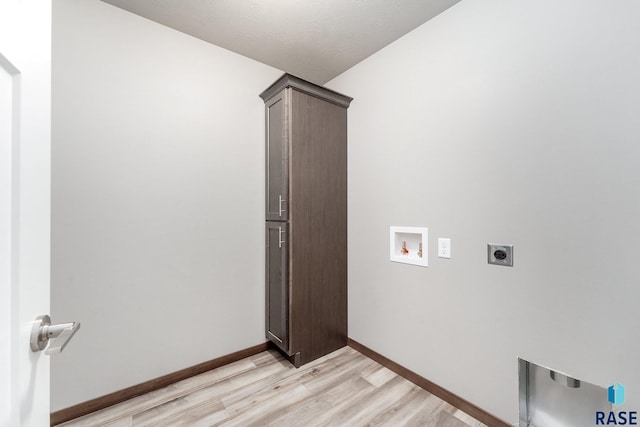 clothes washing area featuring light hardwood / wood-style floors, hookup for a washing machine, cabinets, and hookup for an electric dryer