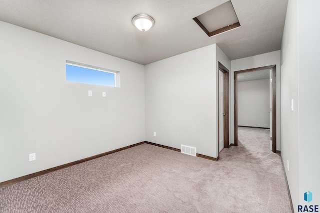 spare room featuring light colored carpet