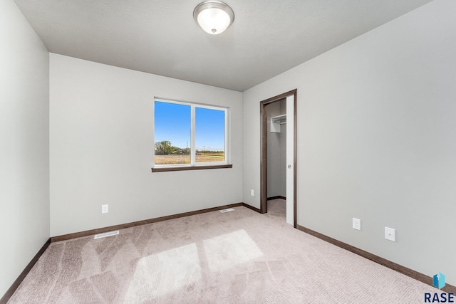 unfurnished room with light colored carpet