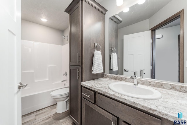 full bathroom with vanity, shower / bathtub combination, toilet, and wood-type flooring