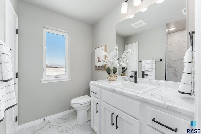 bathroom featuring vanity, toilet, and a shower