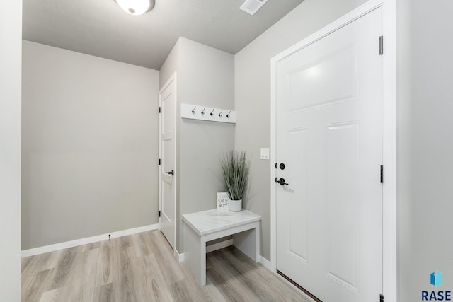 mudroom with light hardwood / wood-style floors