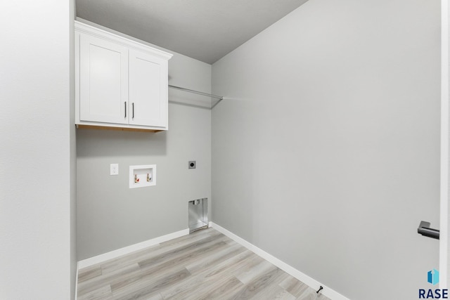 laundry area featuring cabinets, hookup for a washing machine, hookup for an electric dryer, and light wood-type flooring