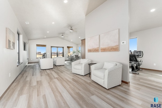 living room featuring ceiling fan, high vaulted ceiling, and light wood-type flooring