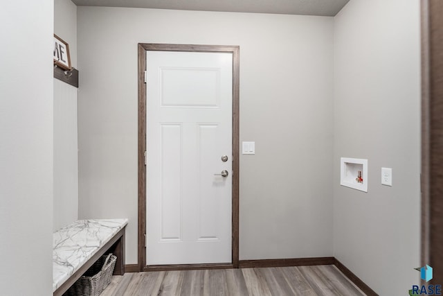 laundry room with hookup for a washing machine and light hardwood / wood-style flooring