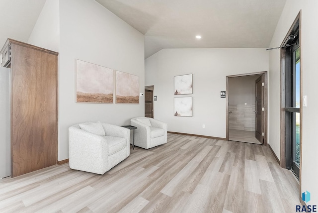 sitting room with lofted ceiling and light hardwood / wood-style flooring