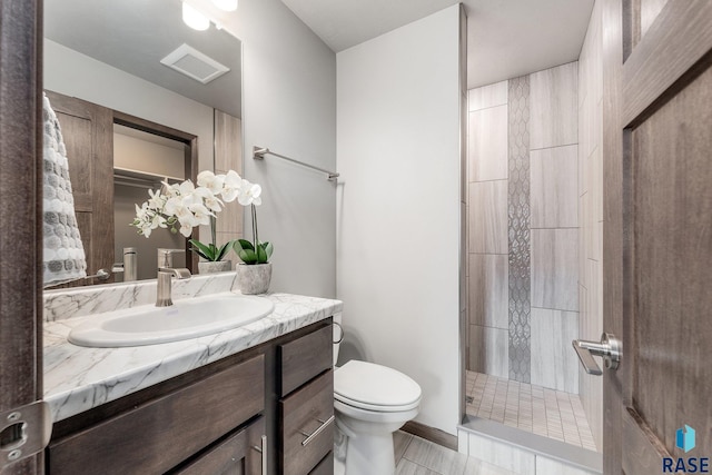 bathroom featuring vanity, toilet, and a shower