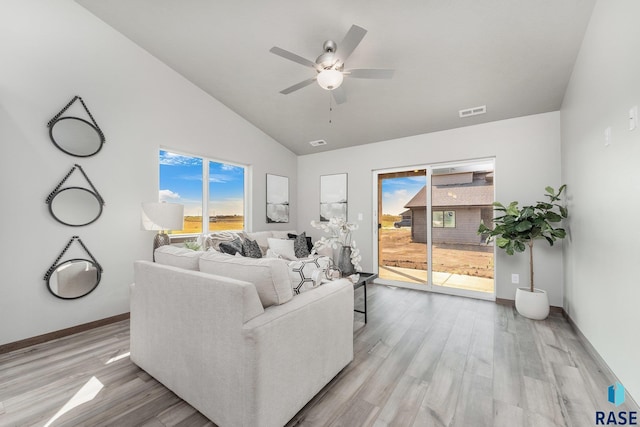 living room with lofted ceiling, light hardwood / wood-style floors, and ceiling fan