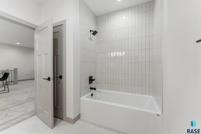 bathroom featuring tile flooring and tiled shower / bath combo