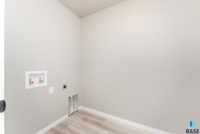 washroom with light hardwood / wood-style floors, washer hookup, and hookup for an electric dryer