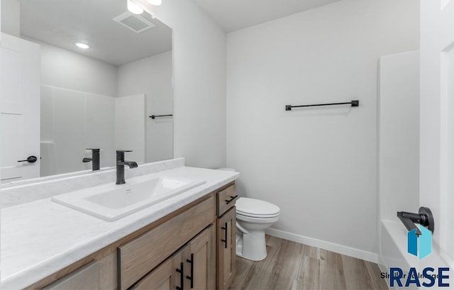 bathroom featuring hardwood / wood-style flooring, vanity, and toilet