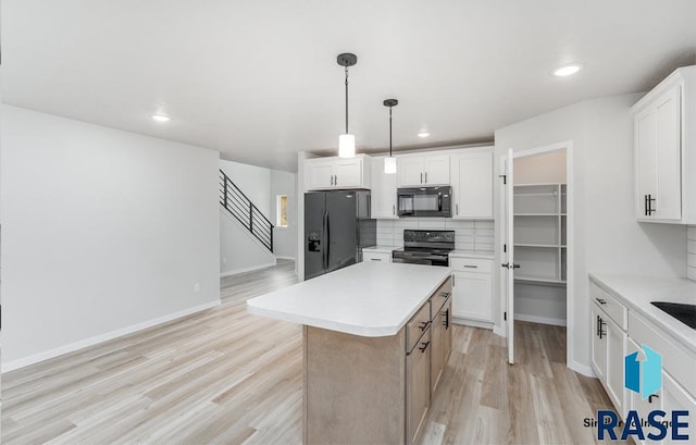 kitchen with tasteful backsplash, black appliances, hanging light fixtures, a kitchen island, and white cabinets