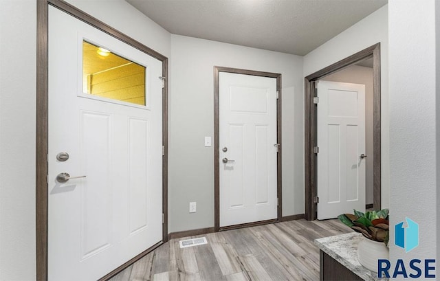 foyer with light hardwood / wood-style floors