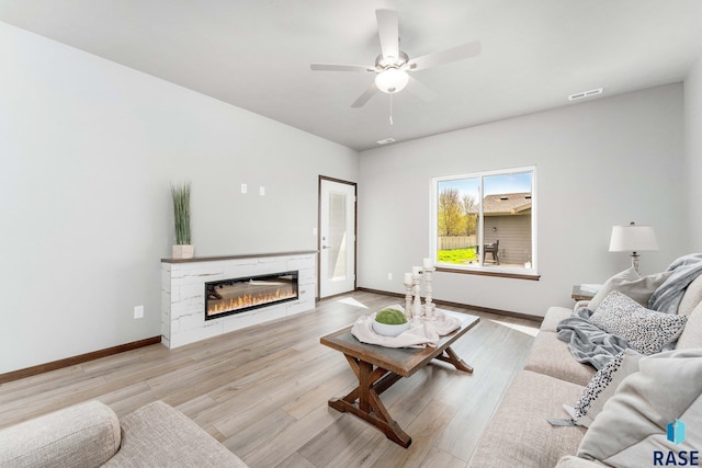 living room featuring ceiling fan and light wood-type flooring