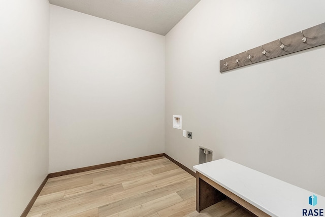 washroom featuring washer hookup, light hardwood / wood-style flooring, and hookup for an electric dryer