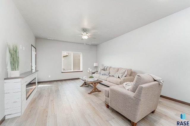 living room with ceiling fan and light hardwood / wood-style floors