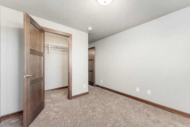 unfurnished bedroom featuring carpet floors and a closet