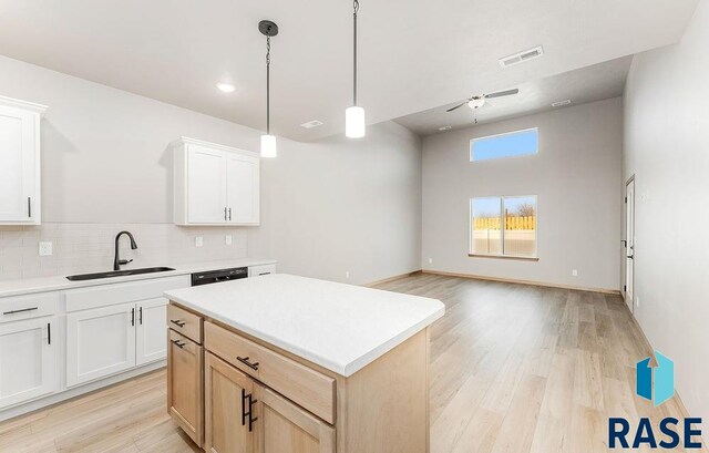 1437 N Mae Pl, Tea, SD 57064 - kitchen featuring white cabinetry, sink, light brown cabinets, and a kitchen island