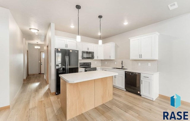 1437 N Mae Pl, Tea, SD 57064 - kitchen with white cabinetry, a center island, and black appliances