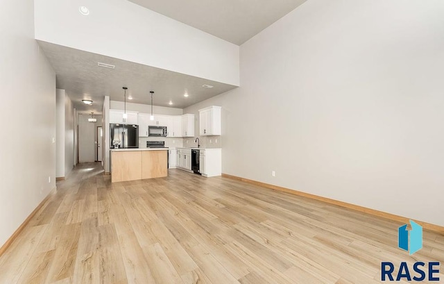 1437 N Mae Pl, Tea, SD 57064 - unfurnished living room featuring sink and light hardwood / wood-style floors