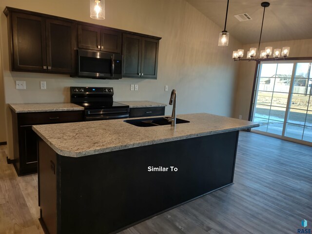 kitchen featuring decorative light fixtures, a kitchen island with sink, black range with electric stovetop, and sink