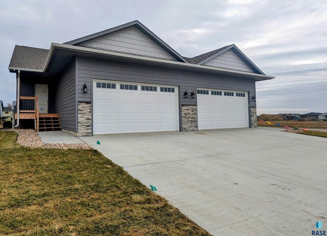 view of front facade with a garage and a front lawn