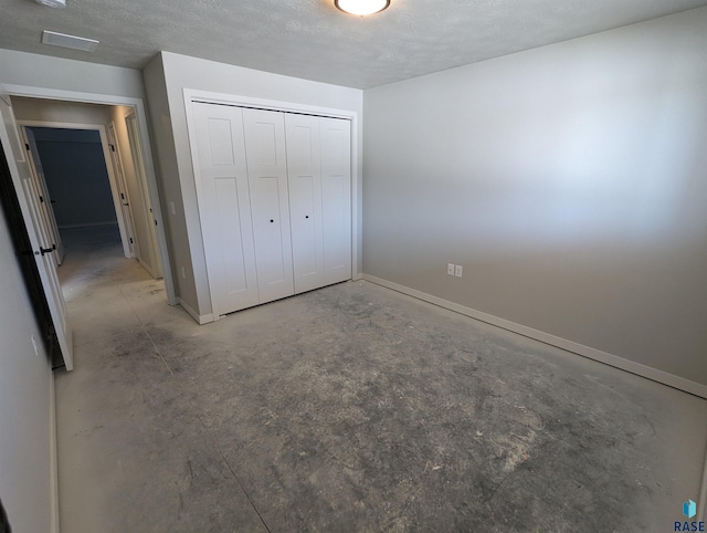 unfurnished bedroom with a closet and a textured ceiling