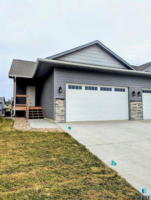 view of property exterior with a yard and a garage