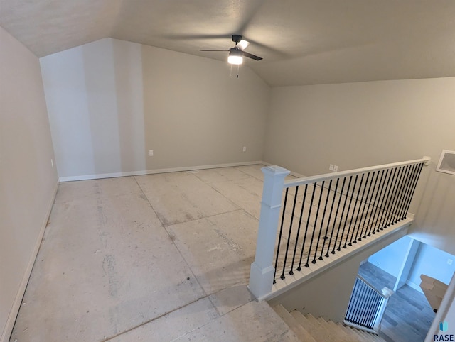 stairway featuring vaulted ceiling and ceiling fan