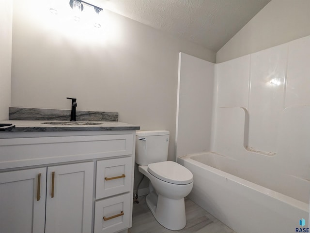 full bathroom with toilet, lofted ceiling, a textured ceiling, vanity, and bathing tub / shower combination