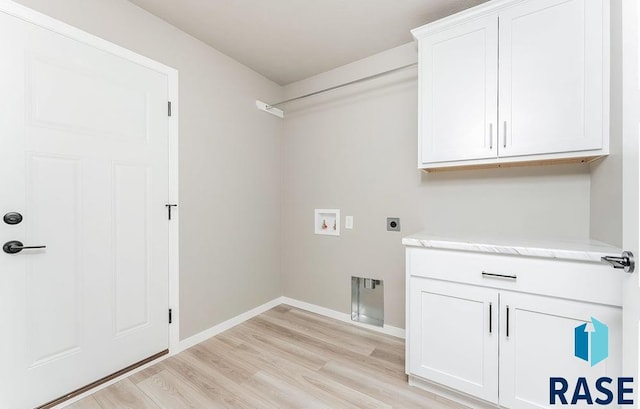 washroom with cabinets, hookup for a washing machine, light hardwood / wood-style floors, and hookup for an electric dryer