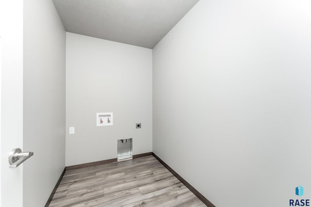 laundry room featuring washer hookup, electric dryer hookup, and light wood-type flooring