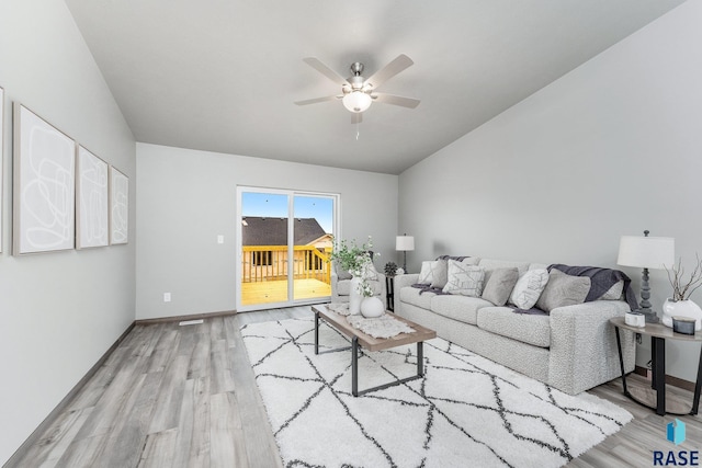 living room with ceiling fan and light hardwood / wood-style floors