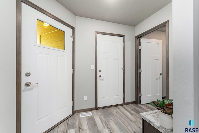 entrance foyer with light hardwood / wood-style flooring