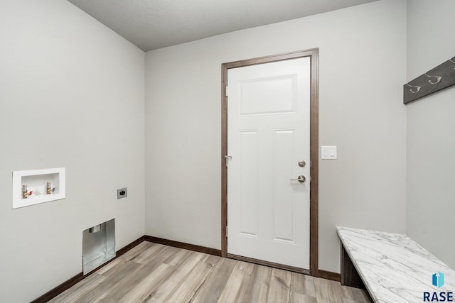 laundry area with washer hookup, light hardwood / wood-style flooring, hookup for an electric dryer, and a textured ceiling