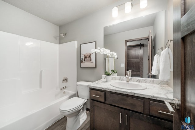 full bathroom featuring vanity, hardwood / wood-style flooring, bathtub / shower combination, and toilet