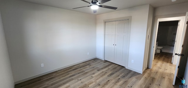 unfurnished bedroom with a closet, wood-type flooring, and ceiling fan