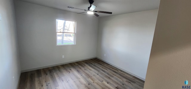 spare room with ceiling fan and light wood-type flooring