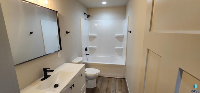 full bathroom with hardwood / wood-style floors, shower / tub combination, oversized vanity, and toilet