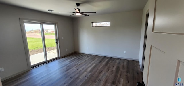 spare room with ceiling fan and dark hardwood / wood-style flooring