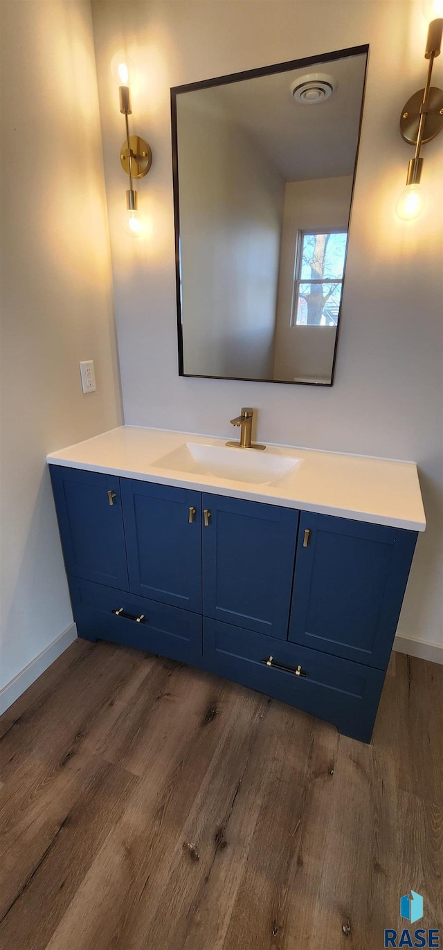 bathroom with vanity and hardwood / wood-style flooring