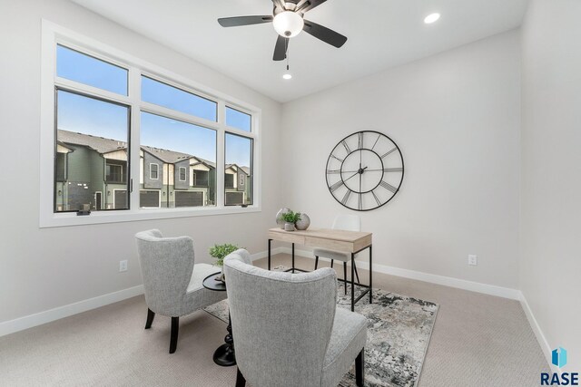 sitting room with ceiling fan and carpet floors