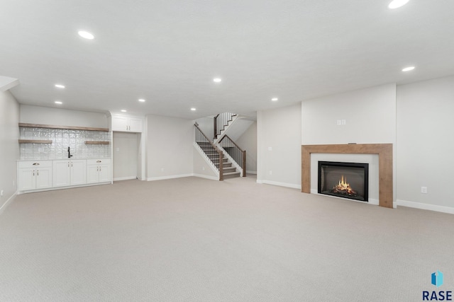 unfurnished living room with light carpet