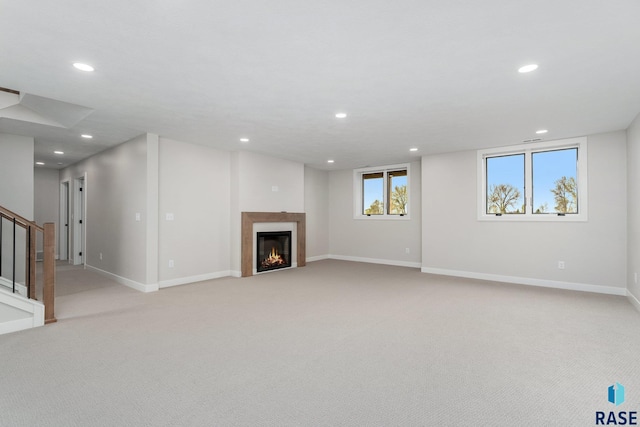 unfurnished living room featuring light colored carpet