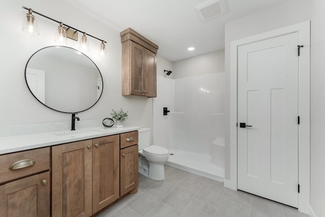 bathroom featuring walk in shower, tile patterned flooring, vanity, and toilet